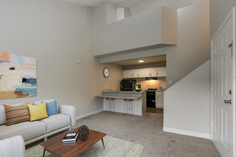 a living room and kitchen with a couch and a coffee table